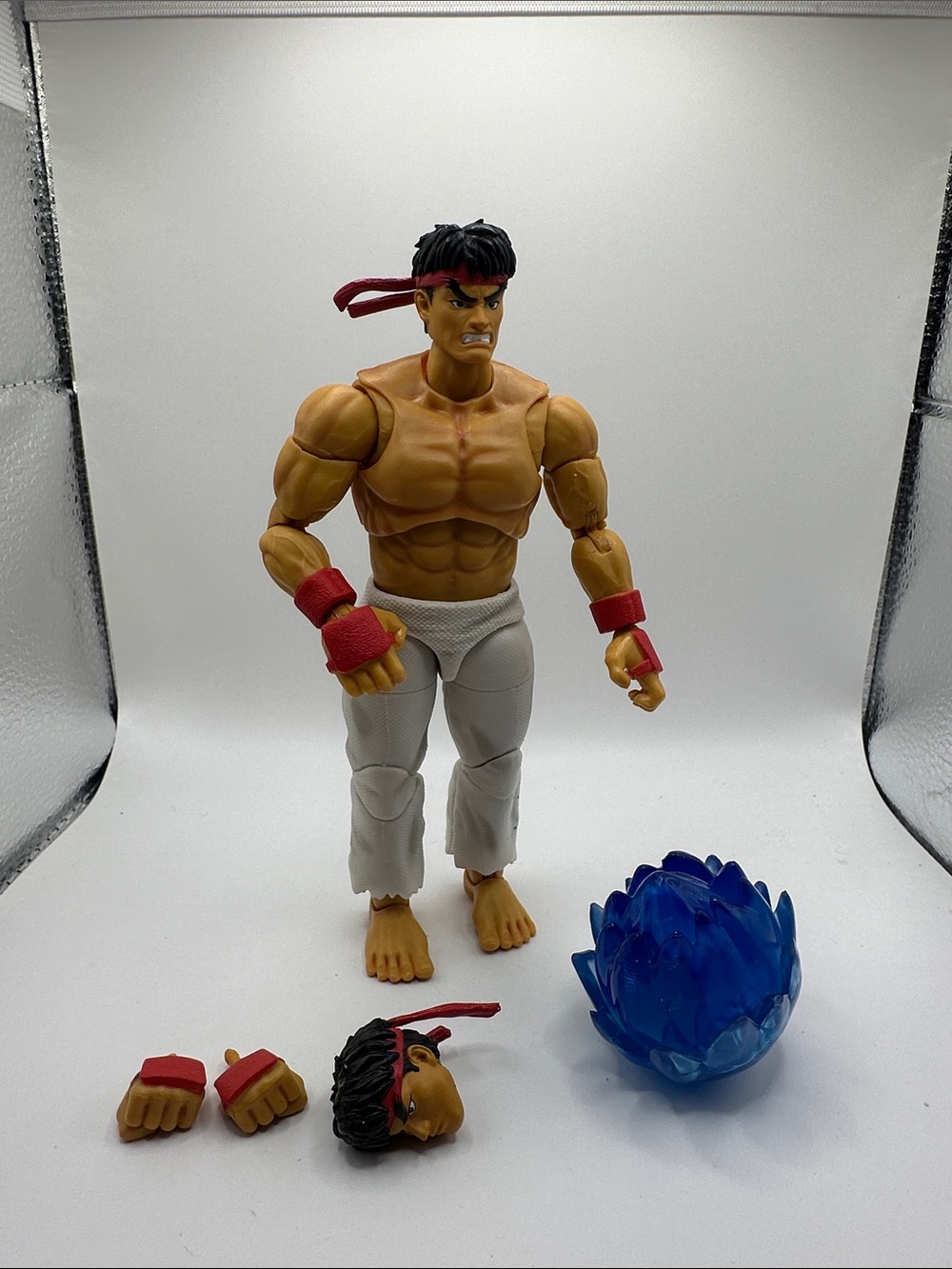 Poseable Martial Artist Action Figure with Red Accents and Blue Energy Effect